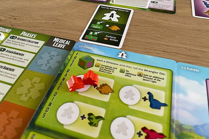 The rival rancher card at the top is blocking the entire card, so I had to place two ranchers to get a Stegosaur.